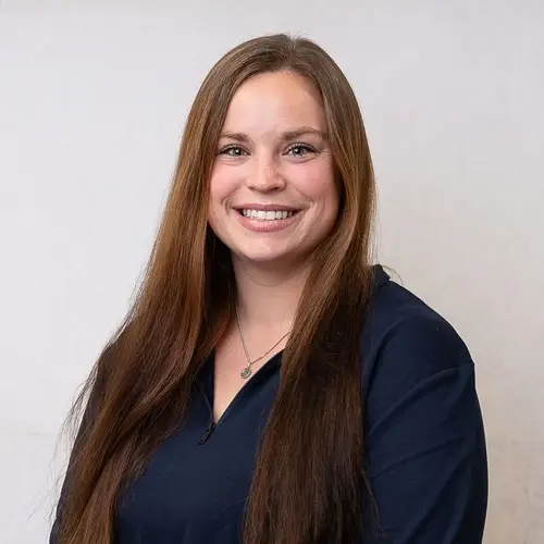 a woman with long brown hair smiling