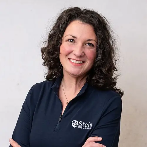 a woman with dark hair wearing a blue shirt